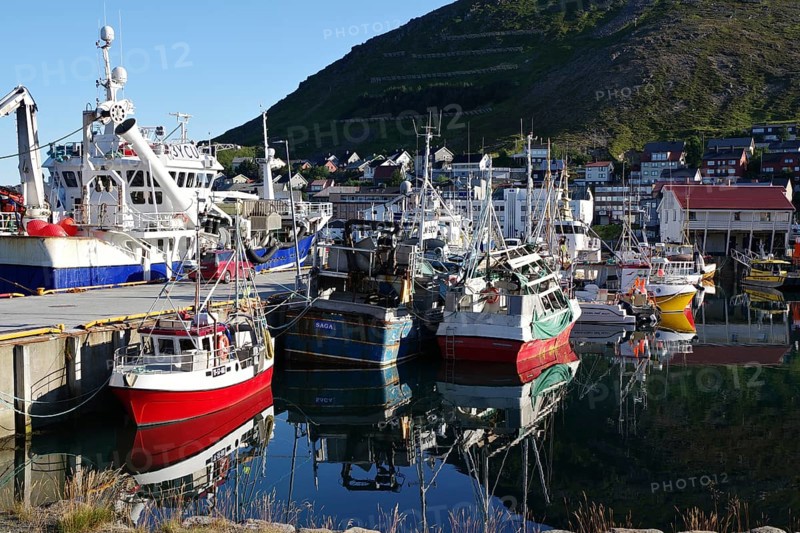 Harbour with small fishing boats reflected in the calm water