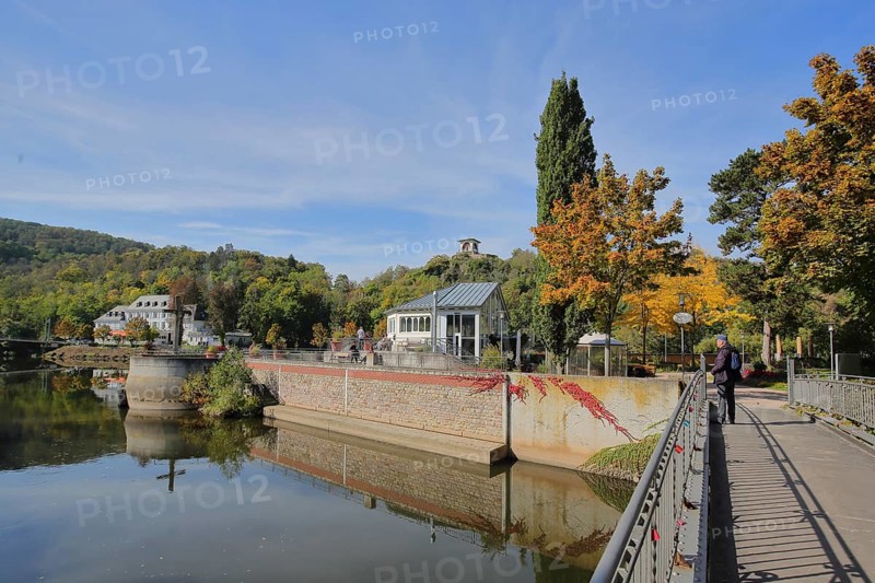 Spa park on the river Nahe in autumn and view of tea temple on the Kauzenberg