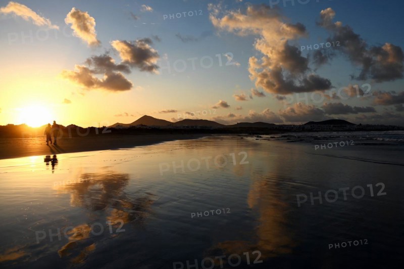Sunset reflected on Caleta de Famara beach