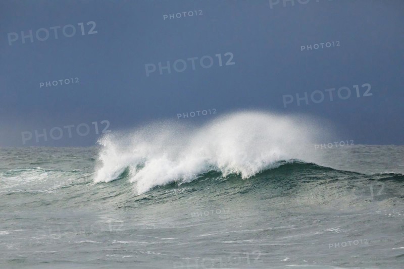 Big wave breaking in the open sea and dramatic light off the north coast of Ireland