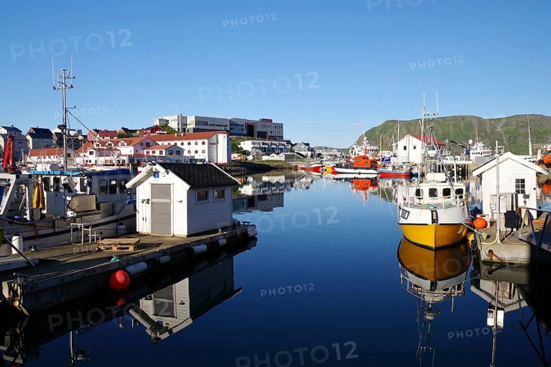 Harbour with small fishing boats reflected in the calm water