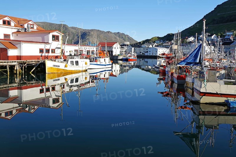 Harbour with small fishing boats reflected in the calm water