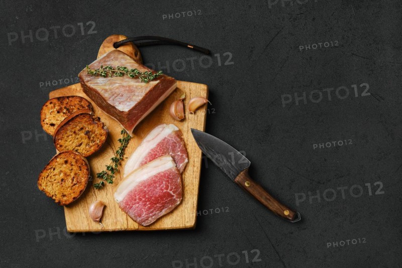 Top view of salted pork belly joint meat with lard on wooden cutting board