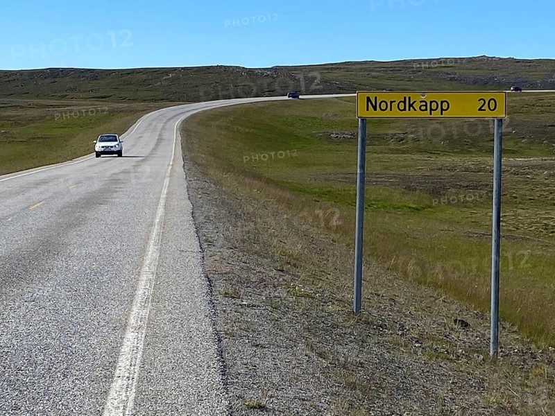 Signpost on a straight road