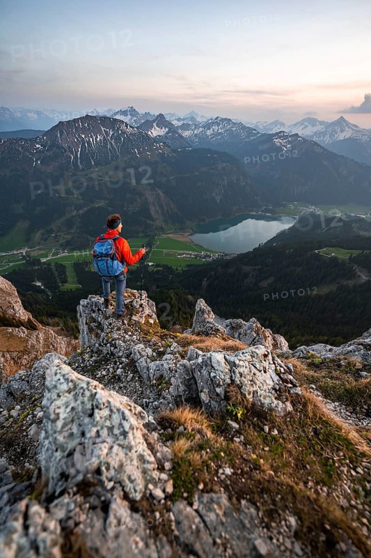 Hiker at the summit of Schartschrofen at sunset