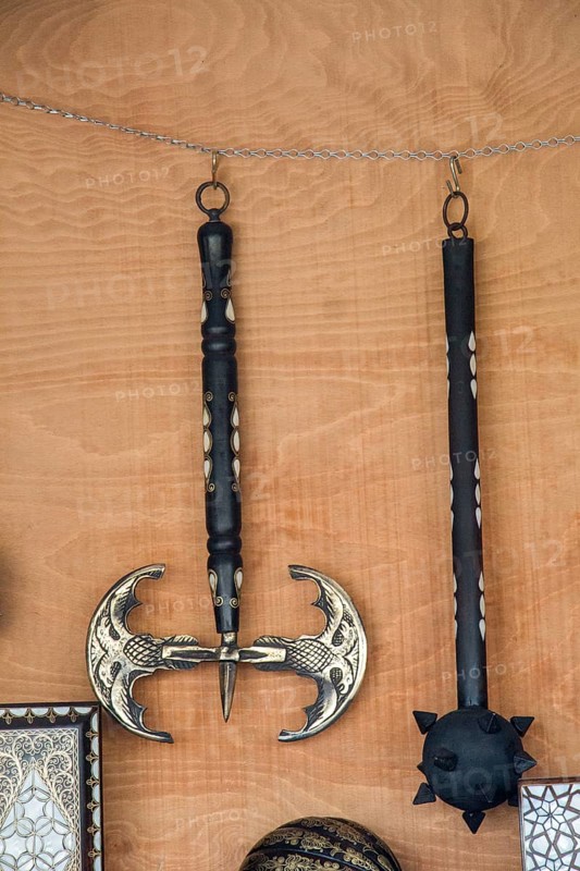 War axe and mace on a wooden background