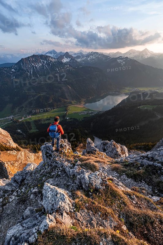 Hiker at the summit of Schartschrofen at sunset
