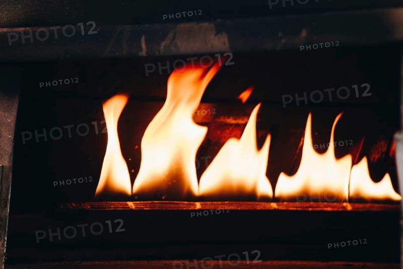 The yellow flames in a stone oven in display