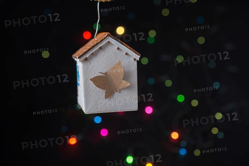 Paper butterfly on a Model house on a bokeh light