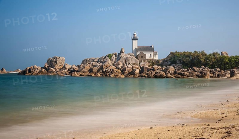 Phare de Pontusval lighthouse on granite rocks on sandy beach Plage du Phare