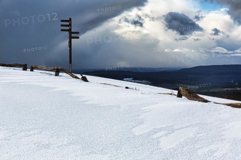 Signpost on mountain top in snow