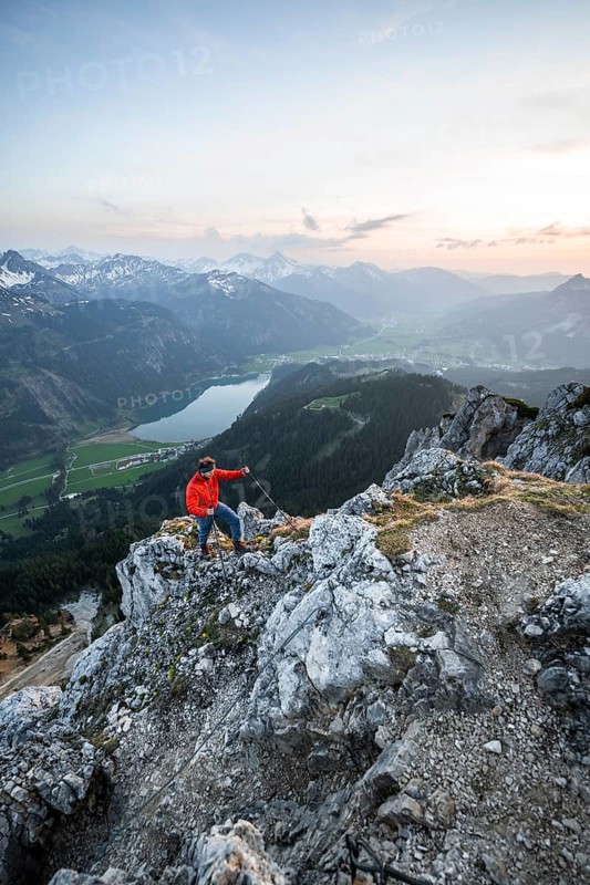 Hiker at the summit of Schartschrofen at sunset