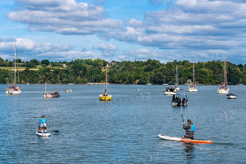 People on Paddle Boards and Yachts on River Dart over Dittisham and Greenway Quay