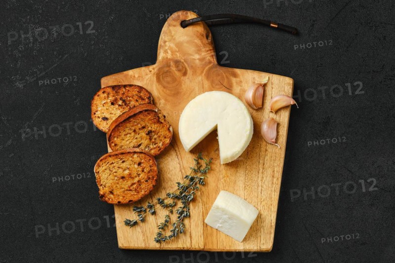 Top view of small goat cheese head and garlic toasted bread