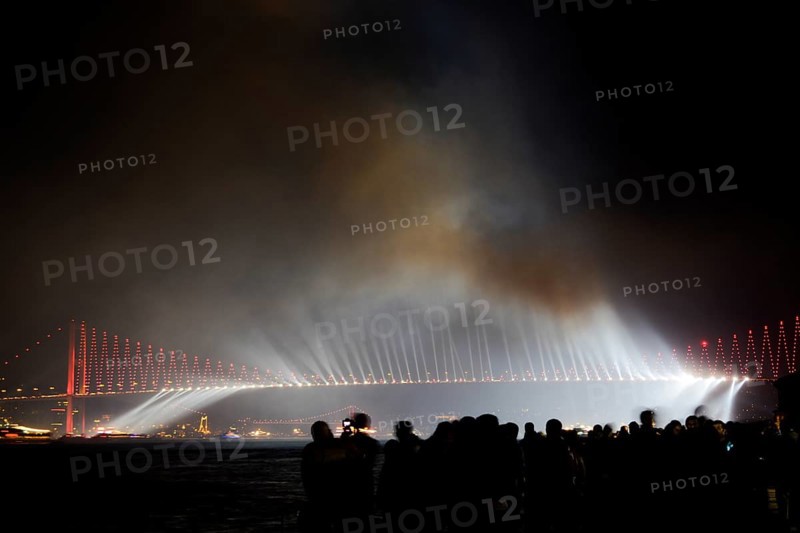 Crowd watch fireworks show over the Istanbul City View of Bosporus Bridge
