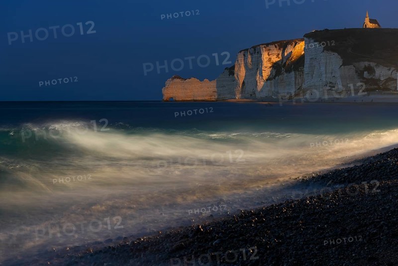 Etretat beach with view of Falaise d'Amont and Chapelle Notre-Dame de la Garde