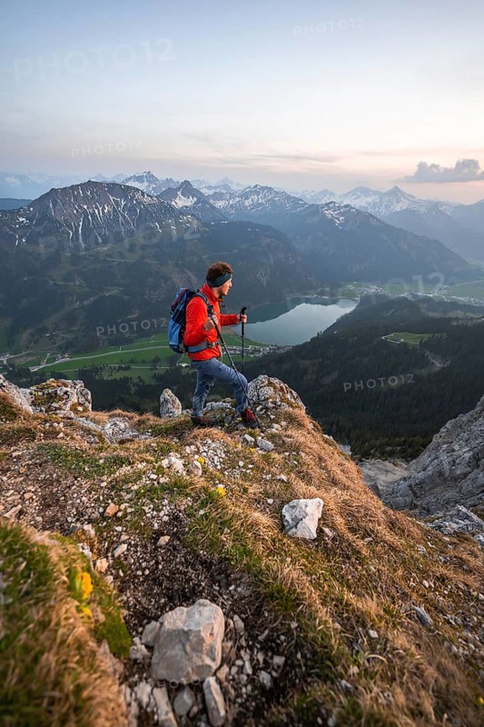 Hiker at the summit of Schartschrofen at sunset