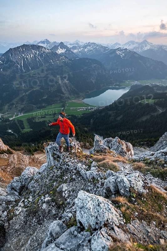 Hiker at the summit of Schartschrofen at sunset