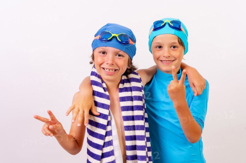 Brothers dressed and hugged in their swimsuits for swimming lessons in the pool in the summer. White background