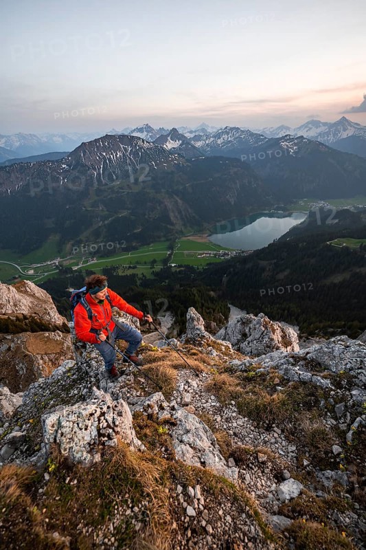 Hiker at the summit of Schartschrofen at sunset