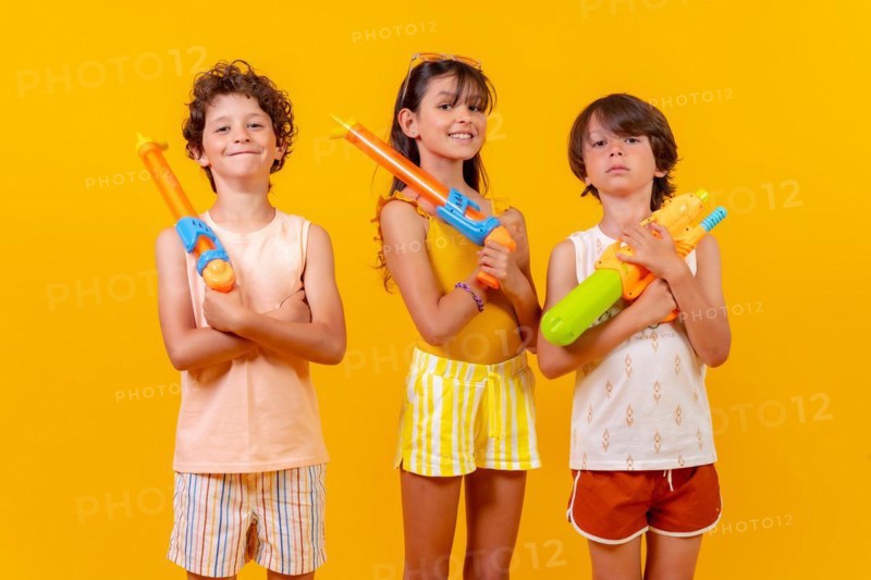 Children with water pistols on summer vacation