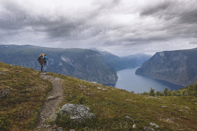 Two woman look from the mountain over the Aurlandsfjord in Norway