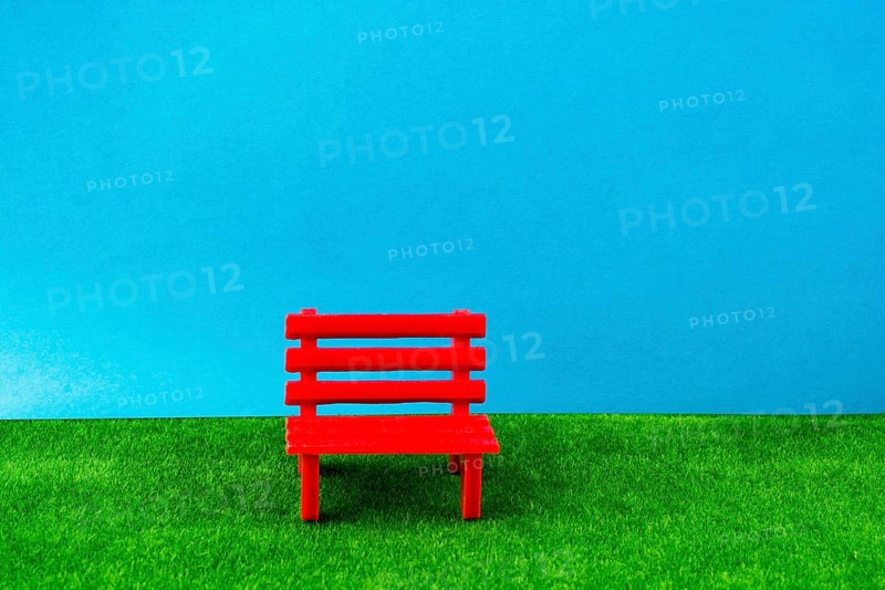 Little red miniature bench made of plastic