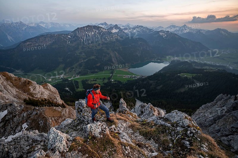 Hiker at the summit of Schartschrofen at sunset