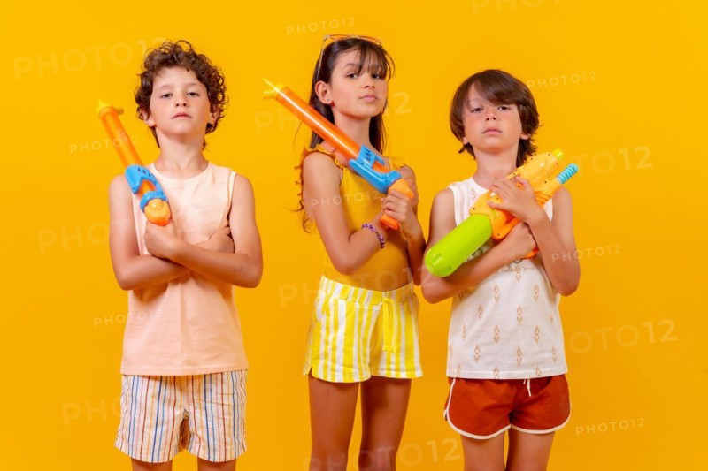 Children with water pistols on summer vacation