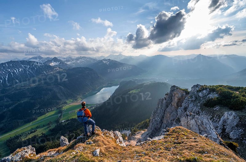 Hiker at the summit of Schartschrofen at sunset