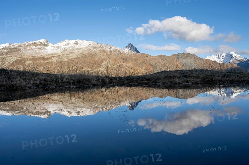 Reflection and view of the mountains at the Bernina Pass