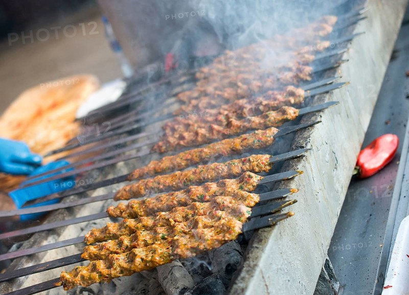 Turkish Adana/Urfa kebab being grilled in the view