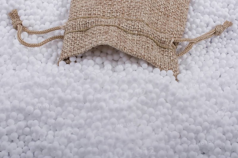 Little sack in White polystyrene foam balls as background