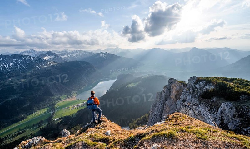 Hiker at the summit of Schartschrofen at sunset