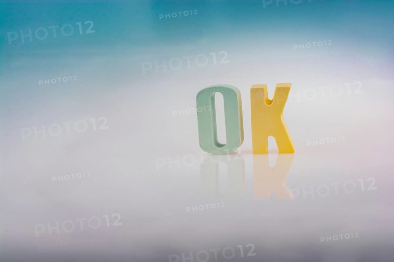 The word OK written with colorful letter blocks