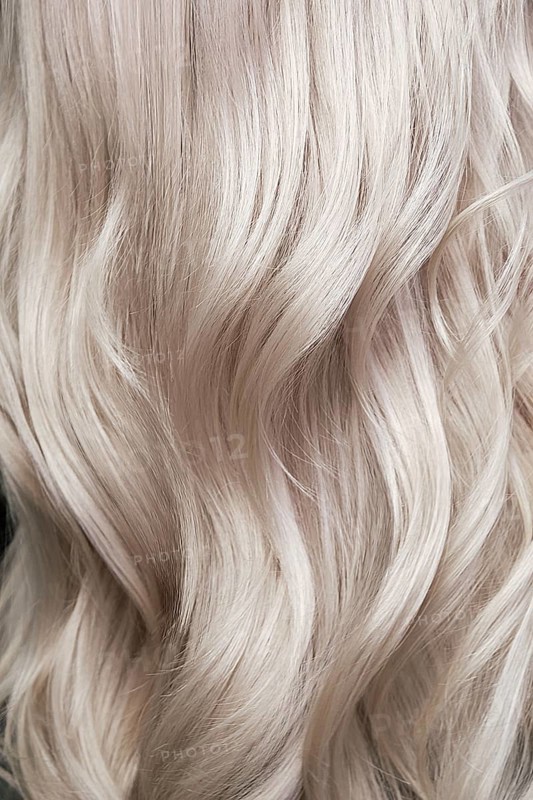 Young woman in a hairdressing salon dyes her hair blond. beauty face and hair. Back view