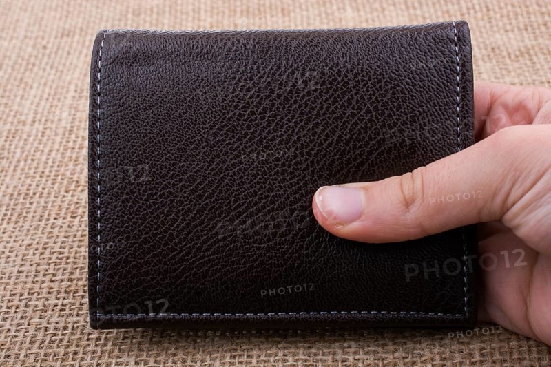 Brown leather wallet in hand saving and finance concept