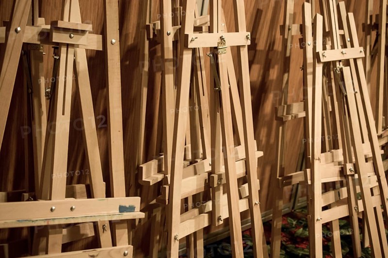 Dozens of of wooden easels in a room