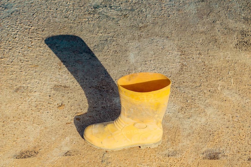 Boots on concrete texture as abstract grunge background