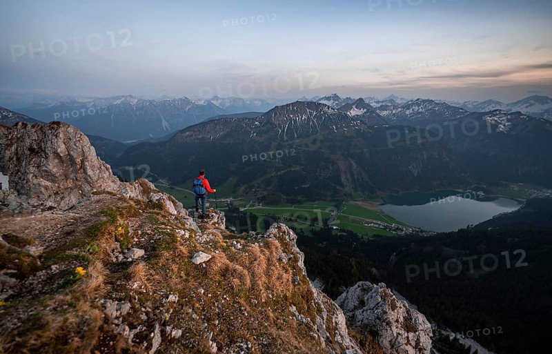 Hiker at the summit of Schartschrofen at sunset