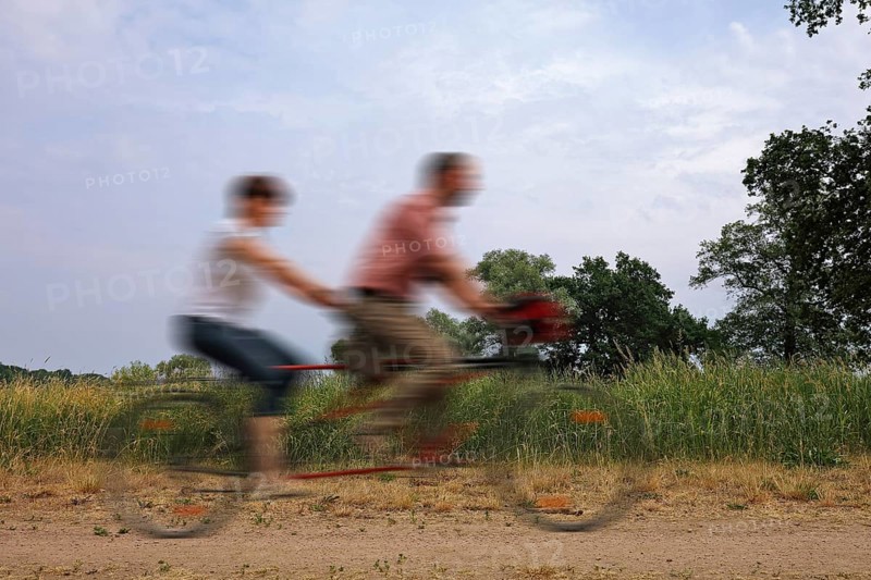 Two people riding on a tandem