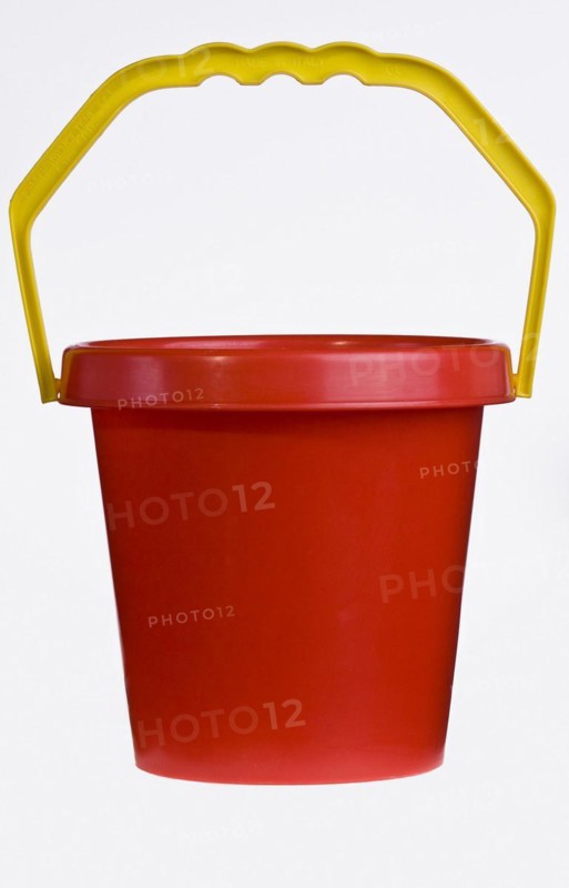 A bright red plastic childs bucket with a yellow handle