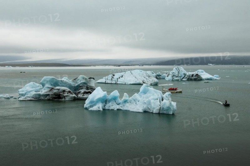 Icebergs and excursion boat in the Joekulsarlon glacier lagoon