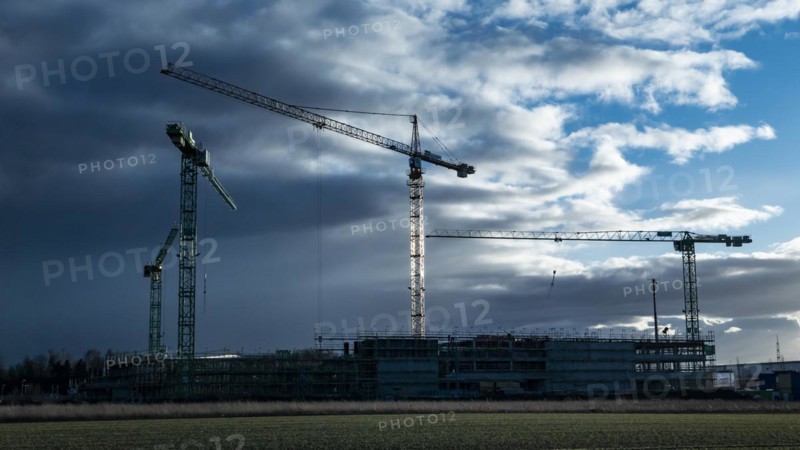 Construction cranes on a building site in Augsburg on the Bundesstrasse 17