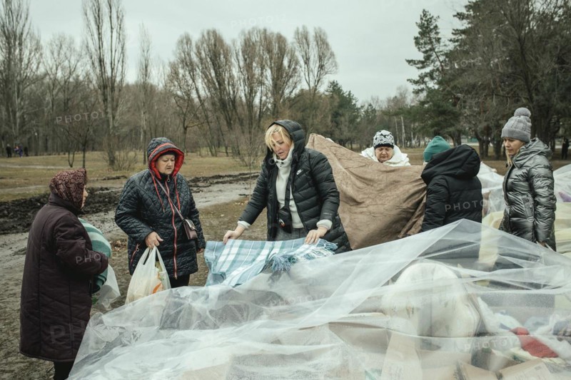 Residents of the house destroyed by a Russian missile attack that killed 45 people receive relief goods from neighbourhood donations