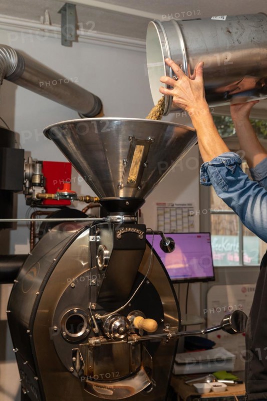 Green coffee is poured into the roasting machine