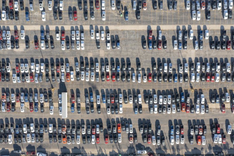 Ford pickup trucks are parked in a vacant warehouse parking lot