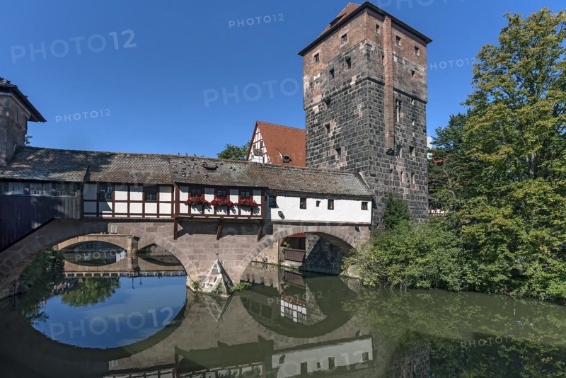 Medieval hangmans bridge and former water tower with reflection in the Pegnitz