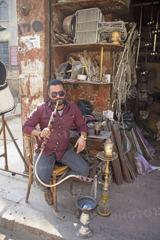 Egyptian man with sunglasses smoking a shisha or hookah