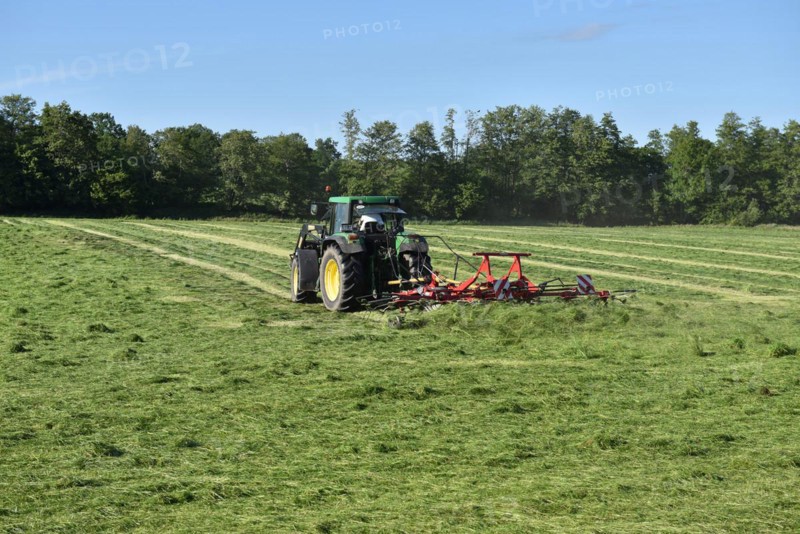 Tractor with hay tedder